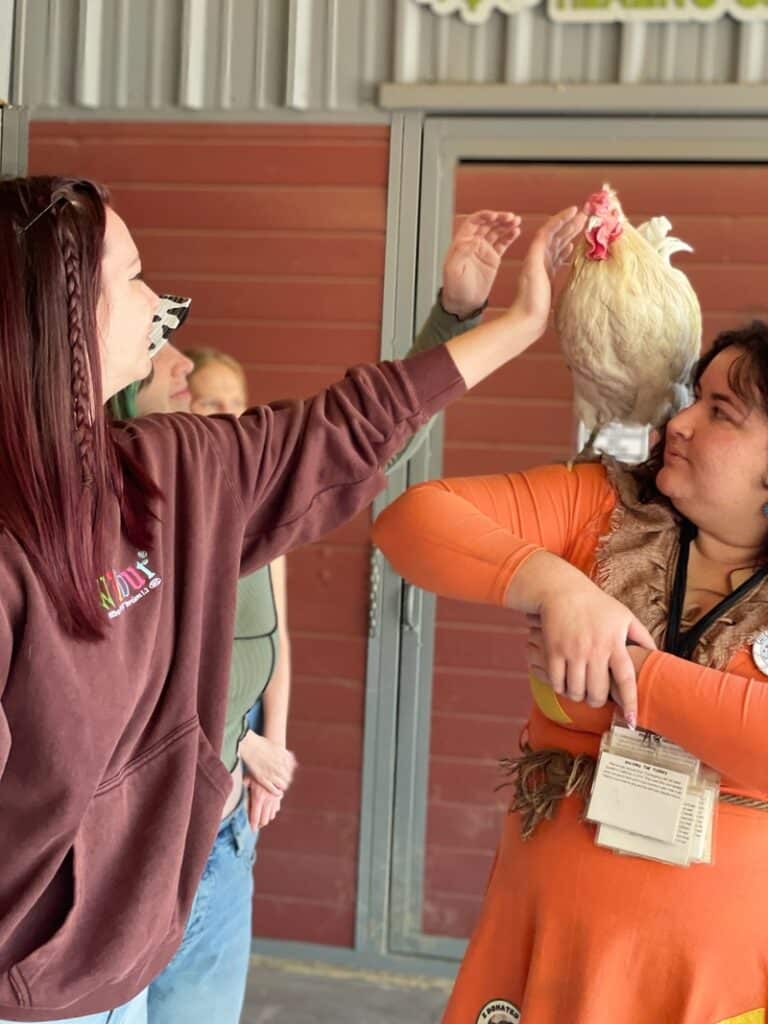 Anya from WhereGalsWander cuddle a chicken at Gentle Barn